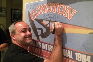 Cesare Cantaglli signs the Gunston event poster from 1984 at the Gunston party in 2014