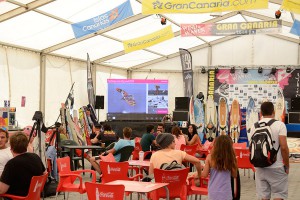 A view inside the tent with a video wall and live action