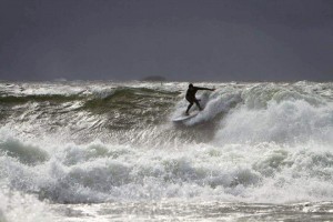 Kai surfs a wave in Finland (Photo by Patrik Blom)